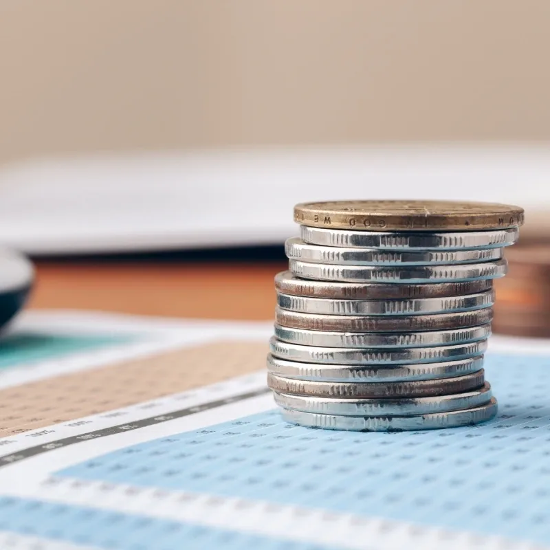 A stack of coins on top of a table.
